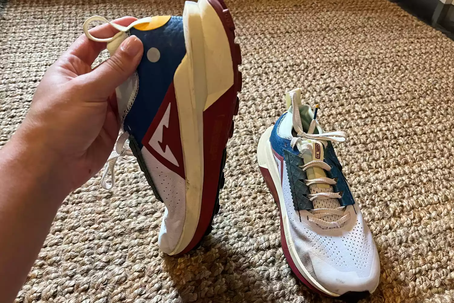 A person holds up the Nike Zegama 2 Women's Trail Running Shoe