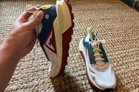 A person holds up the Nike Zegama 2 Women's Trail Running Shoe