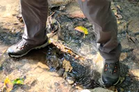 Feet standing in shallow creek while wearing Oboz Bridger 9 Inch Insulated Waterproof Hiking Boot