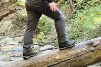 Legs and feet on a log wearing Oboz Bridger 9 Inch Insulated Waterproof Hiking Boot