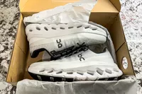 A pair of On Men's Cloudtilt Walking Shoes in a shoebox