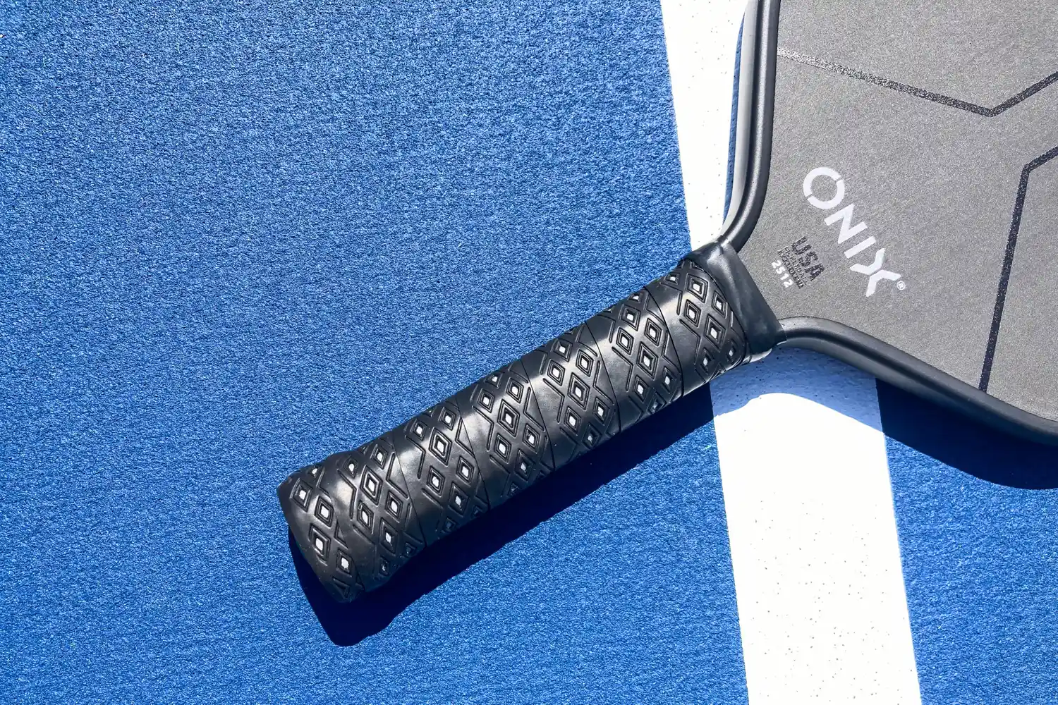 The handle on the Onix Hype X Pro Raw Carbon Pickleball Paddle