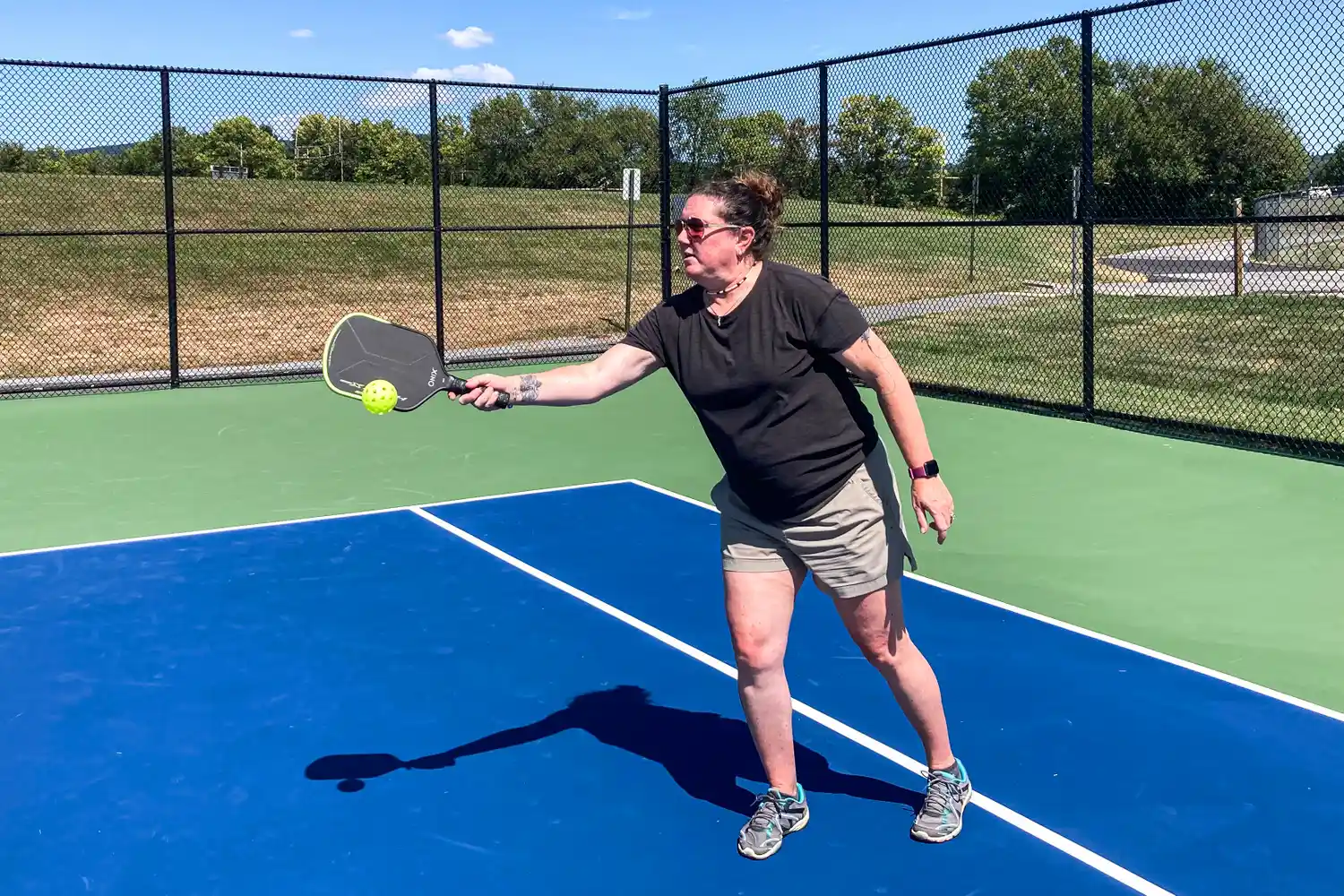 A person plays pickleball with the Onix Hype X Pro Raw Carbon Pickleball Paddle