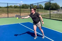A person plays pickleball with the Onix Hype X Pro Raw Carbon Pickleball Paddle
