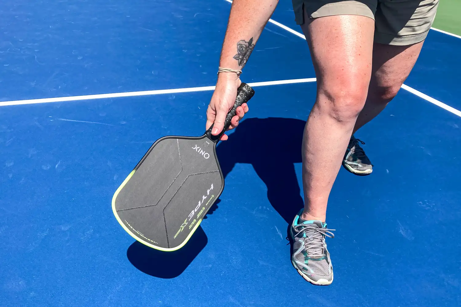 A person plays pickleball with the Onix Hype X Pro Raw Carbon Pickleball Paddle
