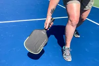 A person plays pickleball with the Onix Hype X Pro Raw Carbon Pickleball Paddle