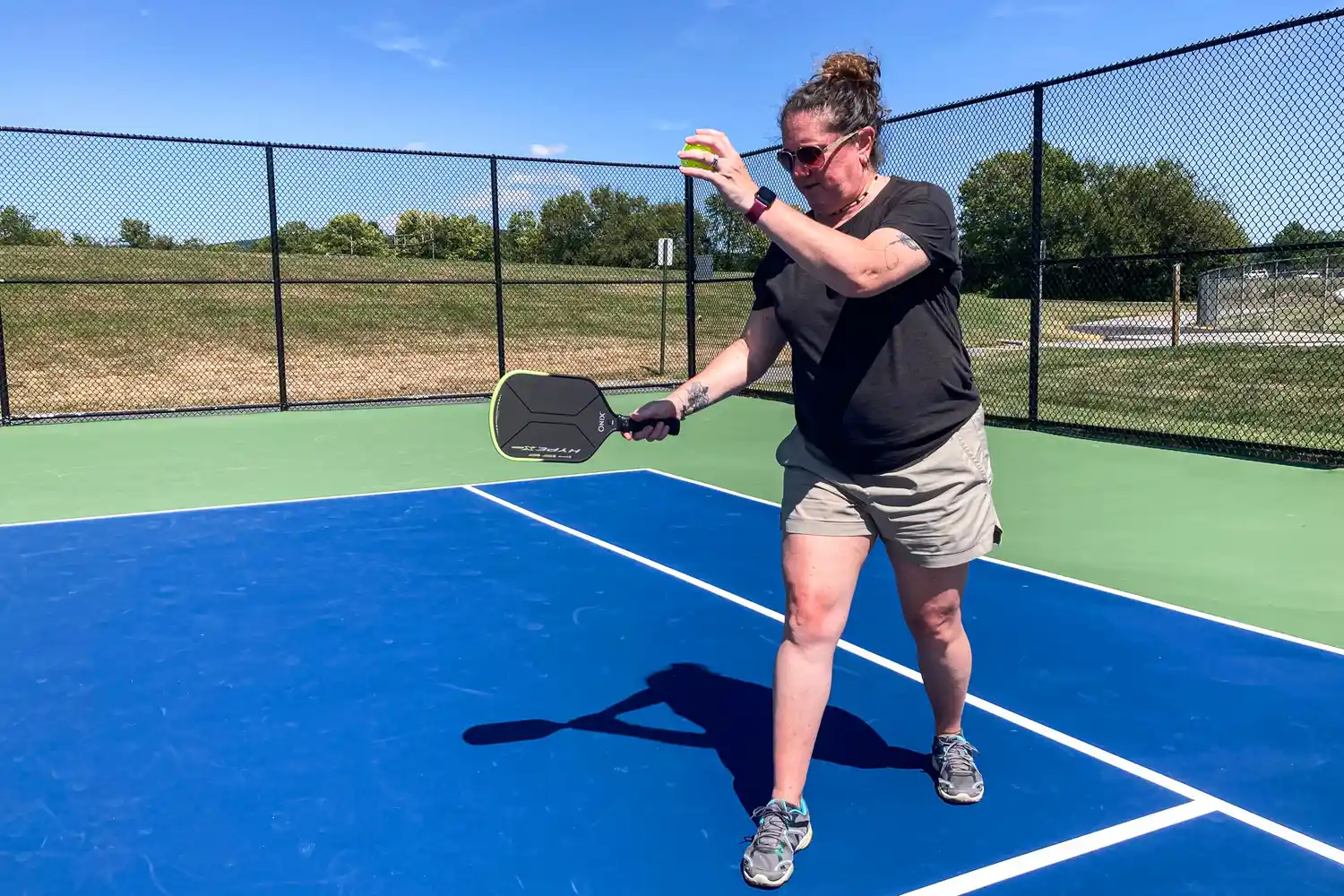 A person uses the Onix Hype X Pro Raw Carbon Pickleball Paddle