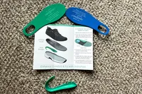 Instruction pamphlet and orthotic shoe inserts for the Orthofeet Women's Relay Sneakers