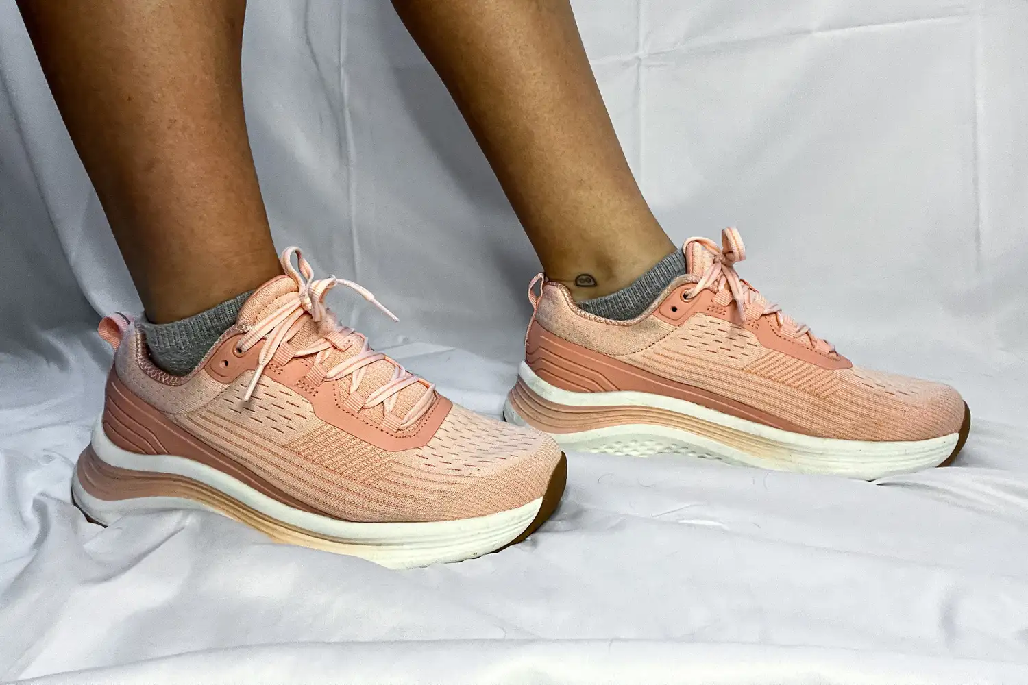 A side view of a person wearing the Orthofeet Women's Relay Sneakers