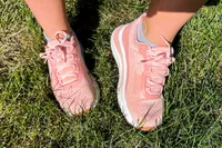 A person wears the Orthofeet Women's Relay Sneakers in grass