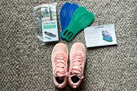 Orthopedic insoles and Orthofeet Women's Relay Sneakers on a carpet