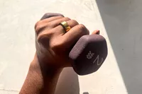 A person wears the Oura Ring 4 while weight lifting