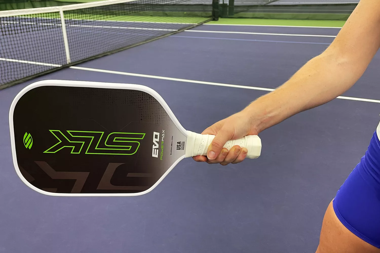 A hand holding the Selkirk SLK Evo Power 2.0 Pickleball Paddle