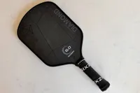 The Six Zero 16mm Double Black Diamond Control Pickleball Paddle on a white countertop