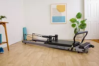 The Balanced Body Allegro Reformer in the corner of a room