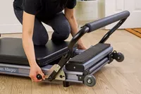 A person adjusts the Balanced Body Allegro Reformer