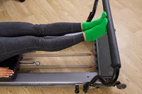 A person exercises using the Balanced Body Allegro Reformer