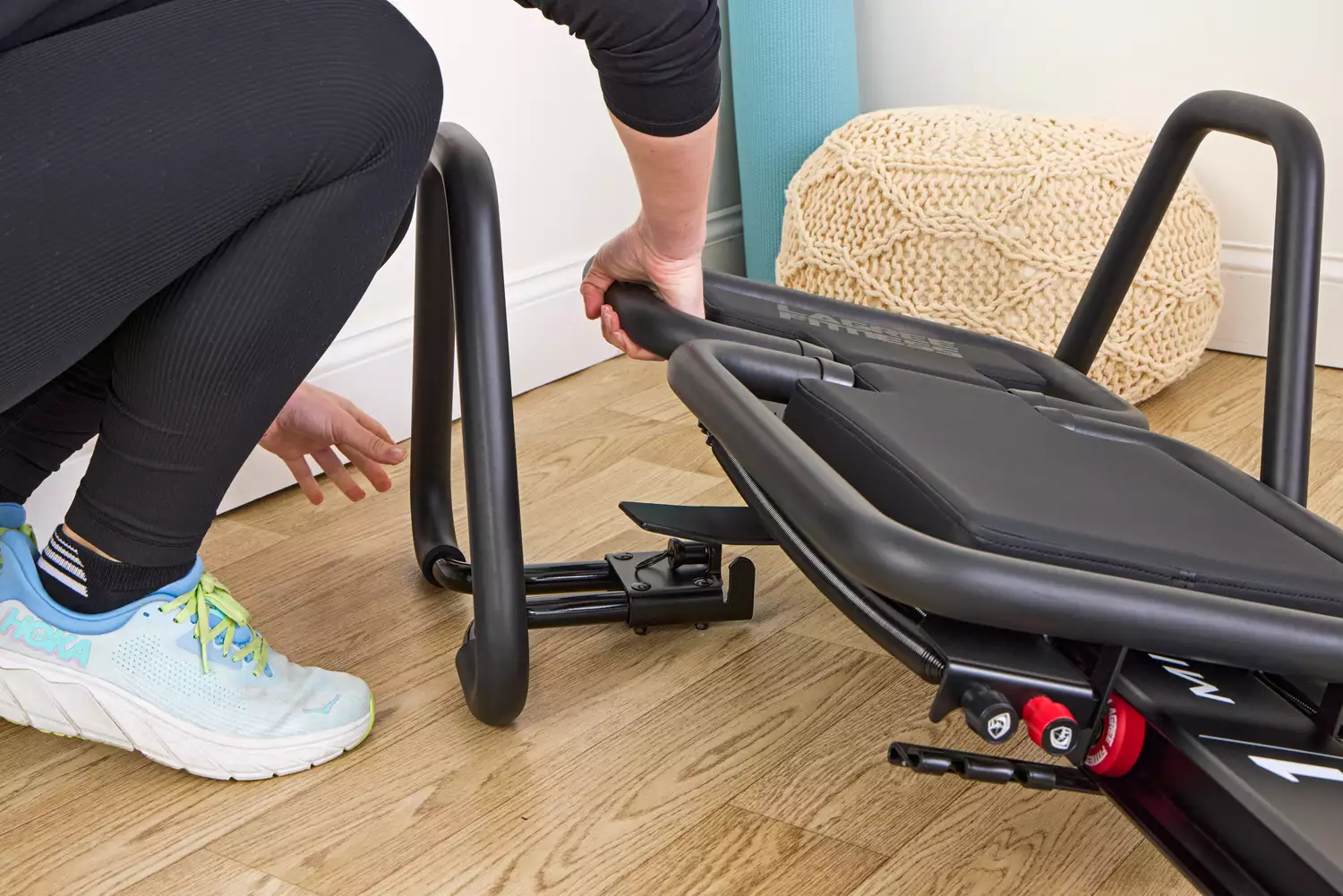 A person assembles the Lagree Micro Reformer