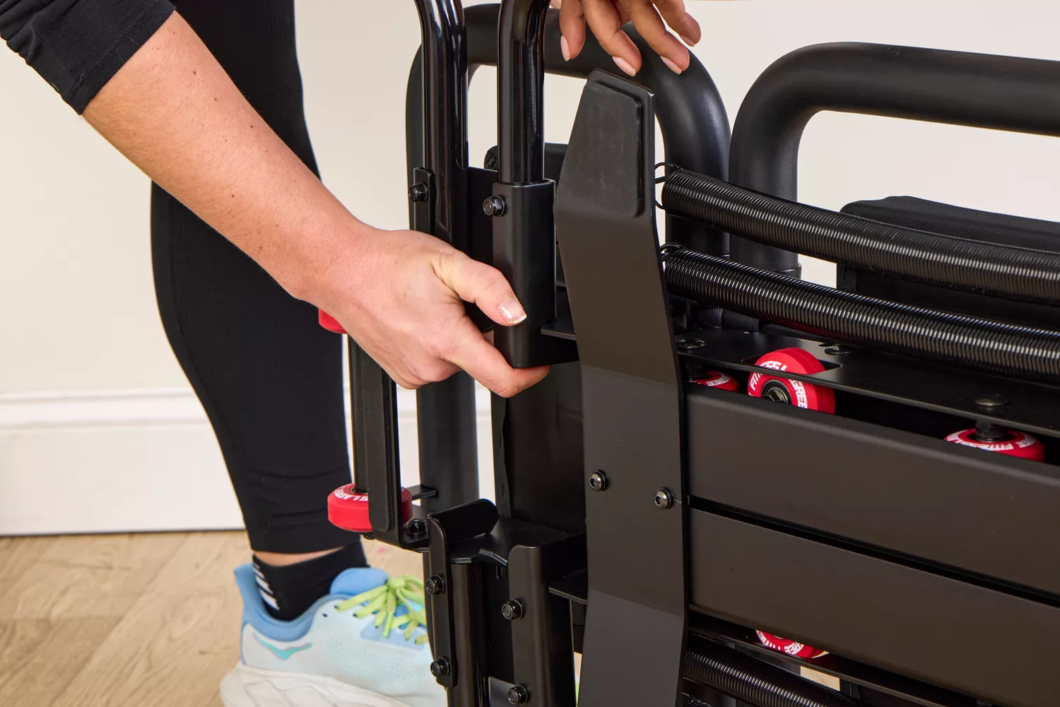 A person adjusts the Lagree Micro Reformer
