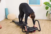 A person exercises using the Lagree Micro Reformer