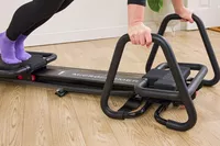 A person exercises using the Lagree Micro Reformer