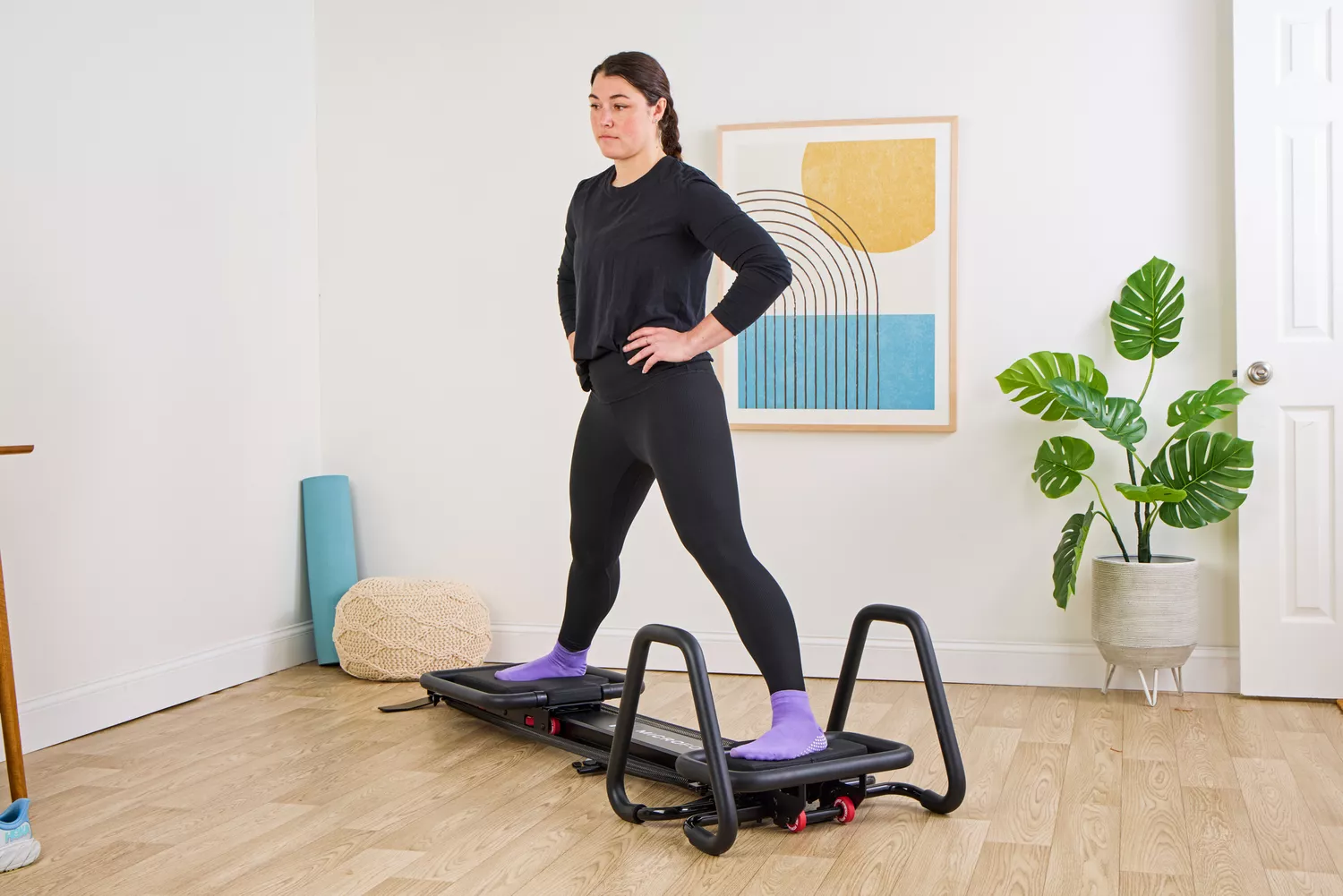 A person exercises on the Lagree Micro Reformer
