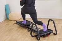 A person exercises using the Lagree Micro Reformer