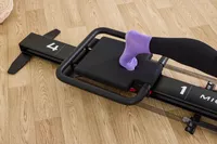 A closeup of a person's foot on the Lagree Micro Reformer