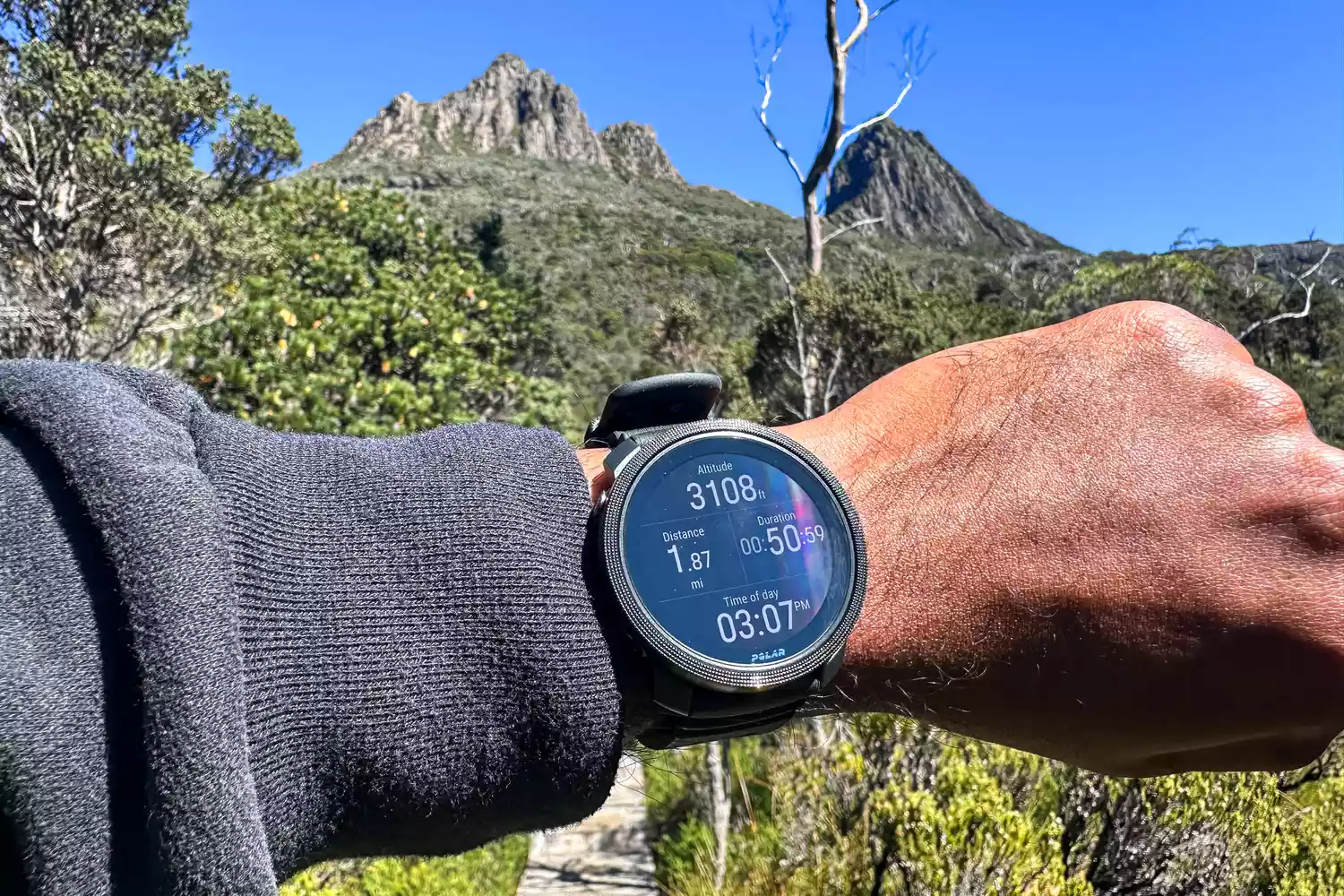 A person wears the Polar Vantage M3 Smart Multi-Sport Watch while hiking