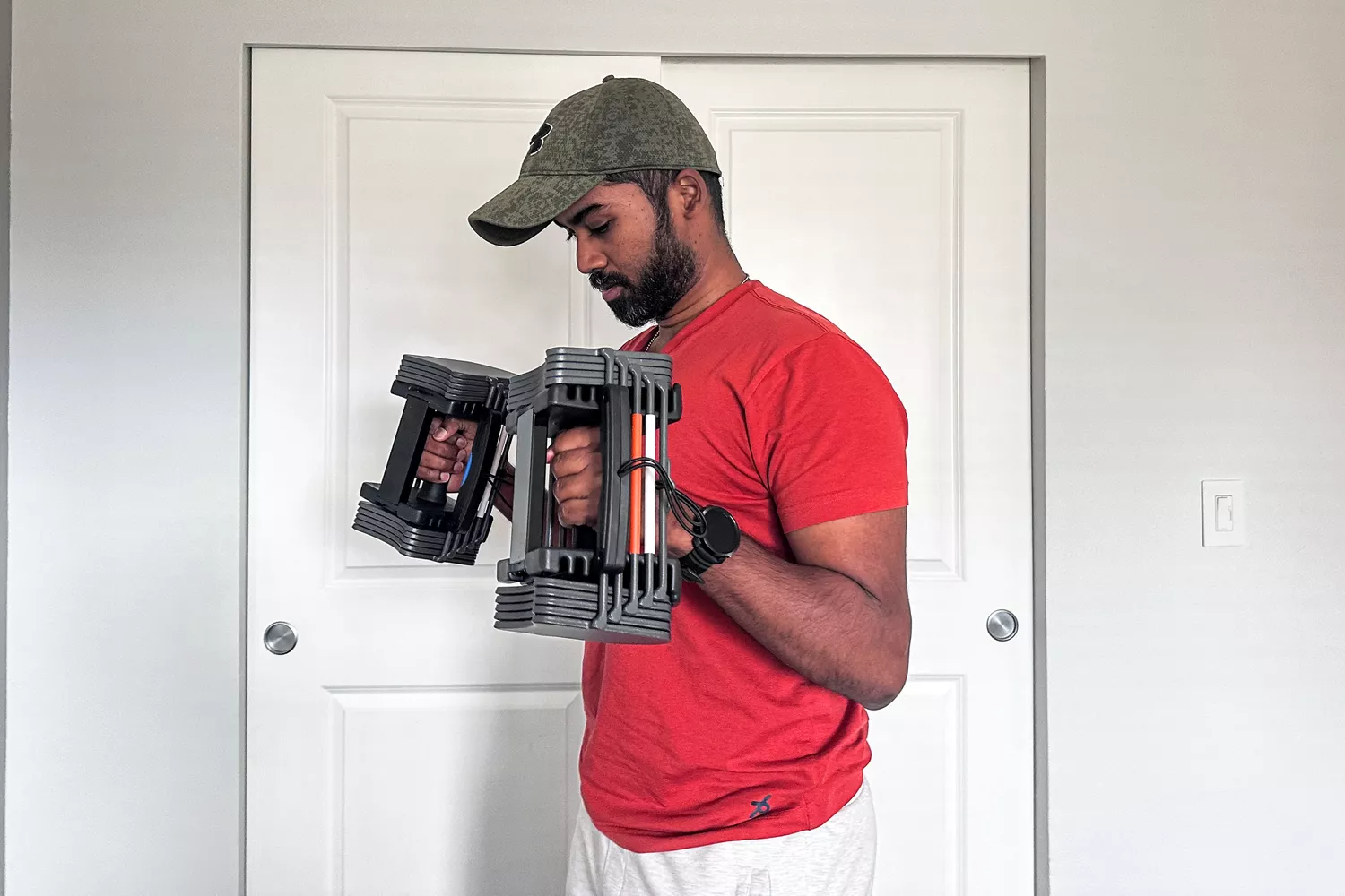 A person lifts the POWERBLOCK Sport 24 Adjustable Dumbbell