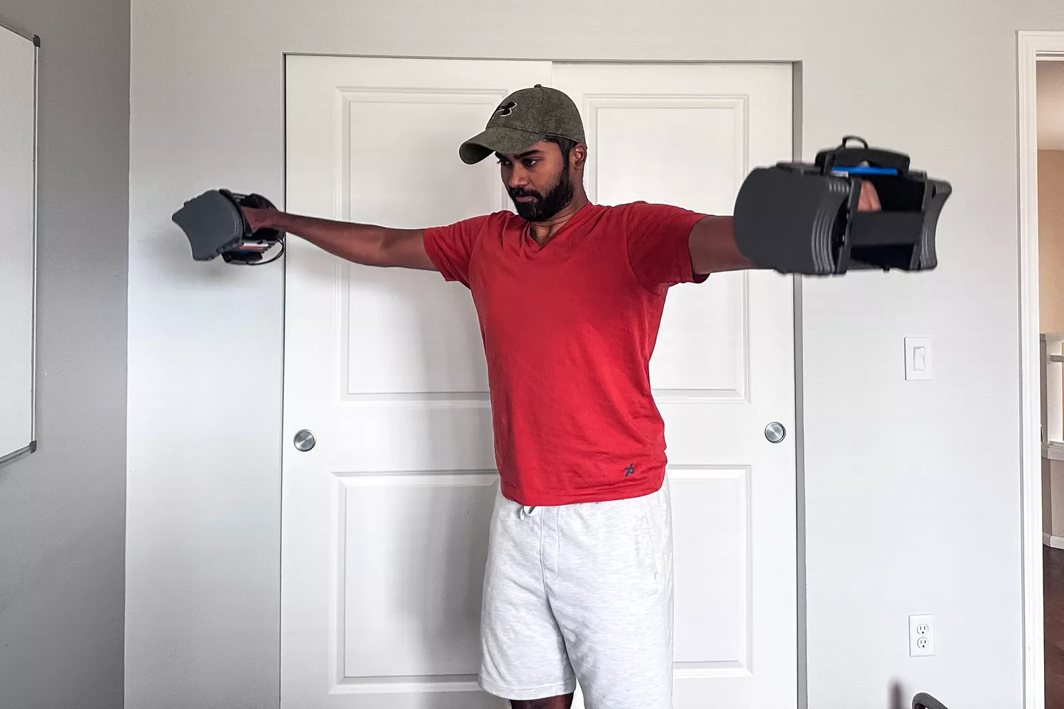 A person lifts up the POWERBLOCK Sport 24 Adjustable Dumbbell