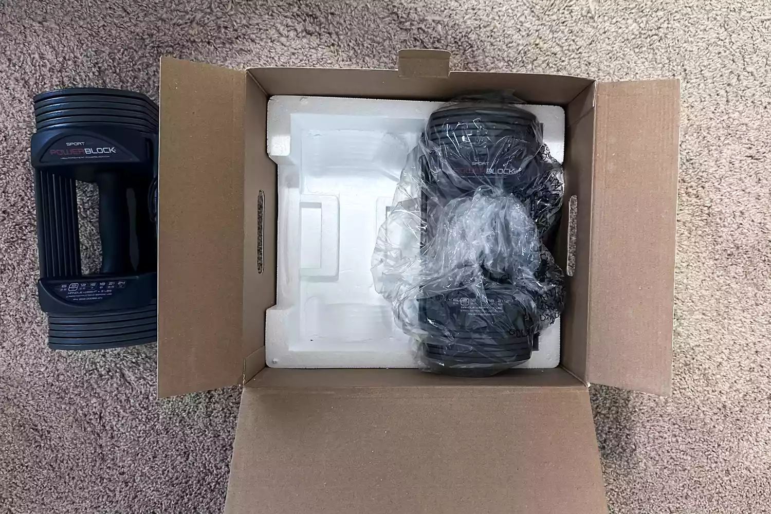 The POWERBLOCK Sport 24 Adjustable Dumbbell in shipping packaging