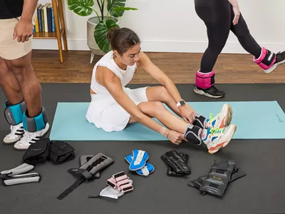  Person putting on Ankle weights 