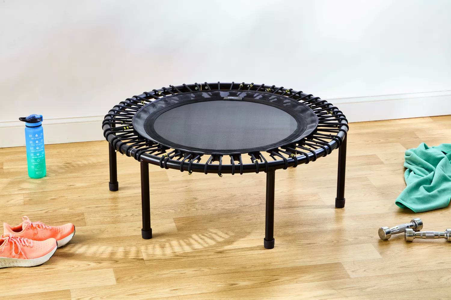 The bellicon 39 Inch Mini Trampoline on a wooden floor next to props