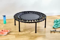 The bellicon 39 Inch Mini Trampoline on a wooden floor next to props