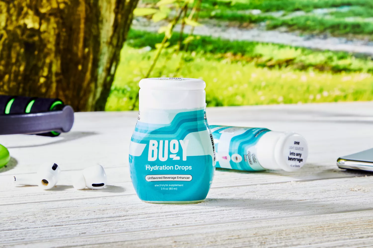 A close up of Buoy Electrolyte Drops on a table outdoors near props