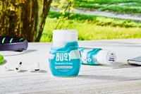 A close up of Buoy Electrolyte Drops on a table outdoors near props