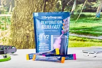DripDrop Hydration Electrolyte Powder Packets on a table outside next to props