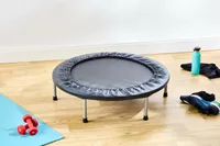 The Fitness Gear Mini Trampoline in a room with workout gear