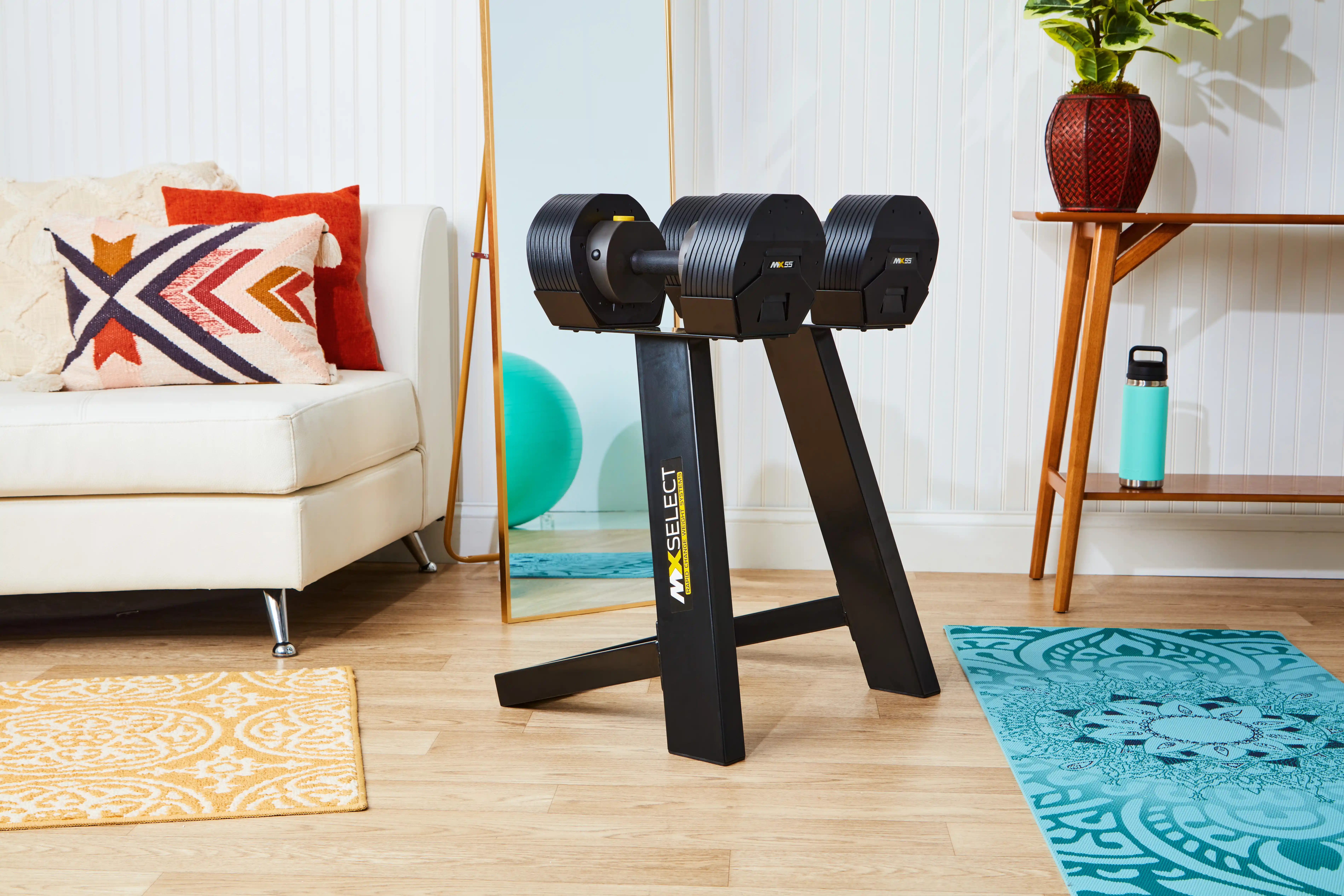 MX55 Rapid Change Adjustable Dumbbells on stand in living space 