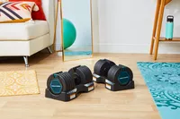 ProForm Select-a-Weight Dumbbells on floor stands next to yoga mats