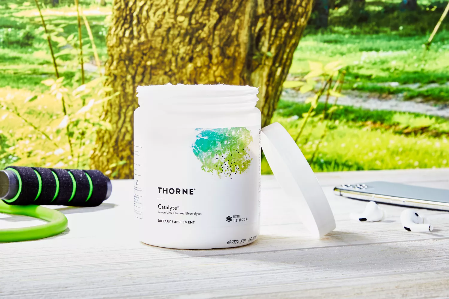 Thorne Research Catalyte jar on a wooden table outdoors