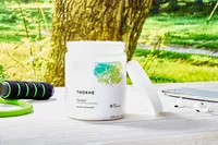 Thorne Research Catalyte jar on a wooden table outdoors