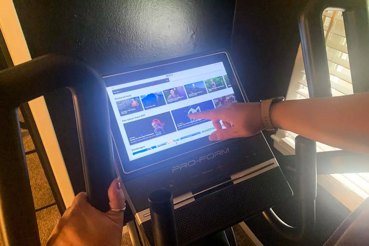 A person presses a button on the ProForm Cardio HIIT H14 Trainer digital display