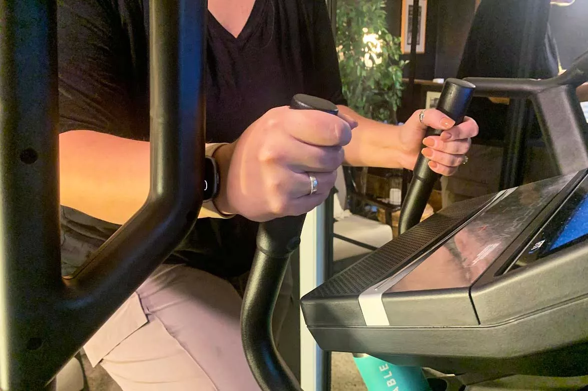 A person holds the arm bars on the ProForm Cardio HIIT H14 Trainer