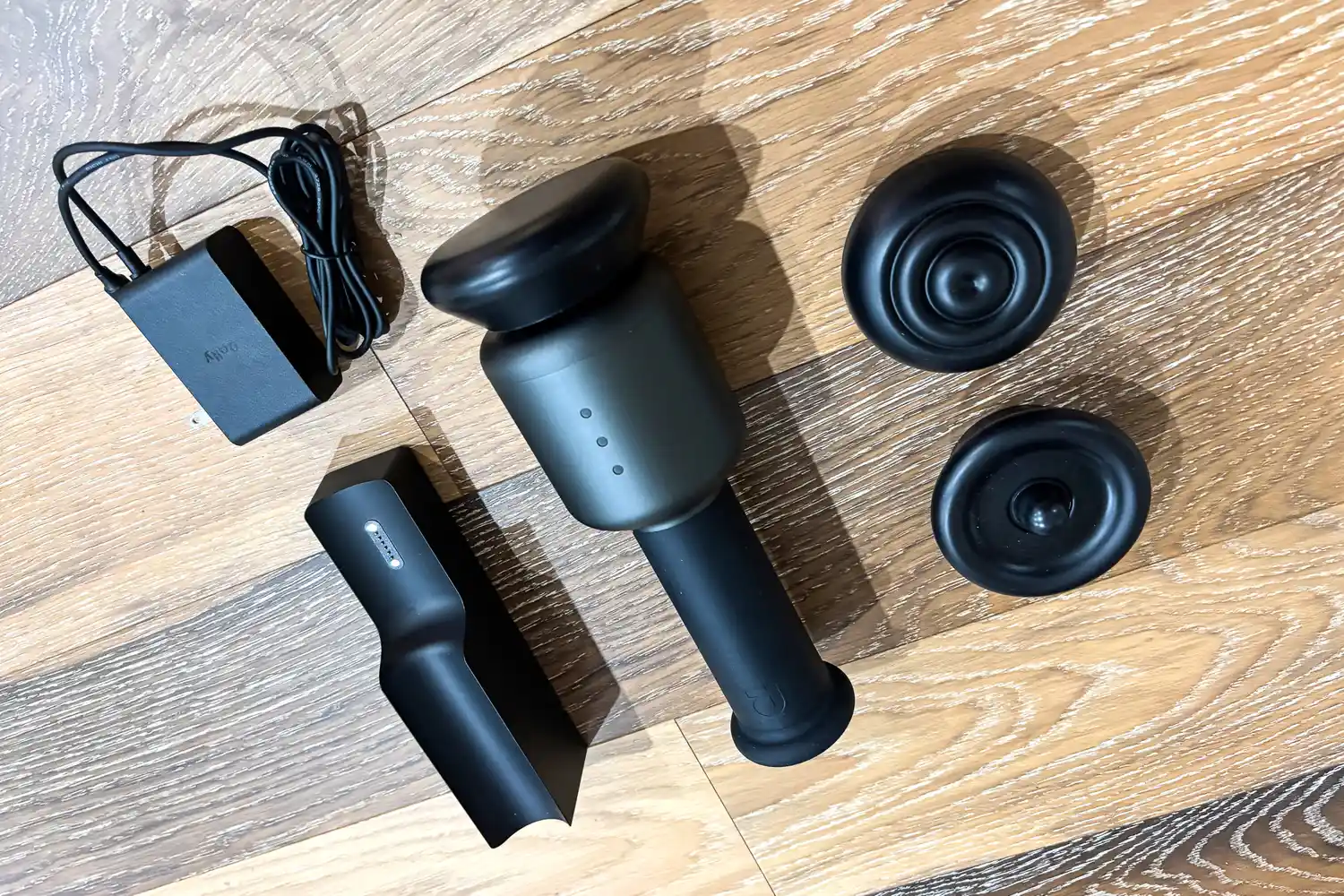 The pieces of the Rally Massage Gun before use