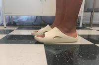 Person wearing Crocs Mellow Recovery Slides on tiled floor