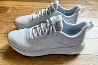 A side view of a pair of Reebok Unisex DMX Comfort+ Walking Shoes