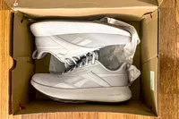 The Reebok Unisex DMX Comfort+ Walking Shoes in a shoebox