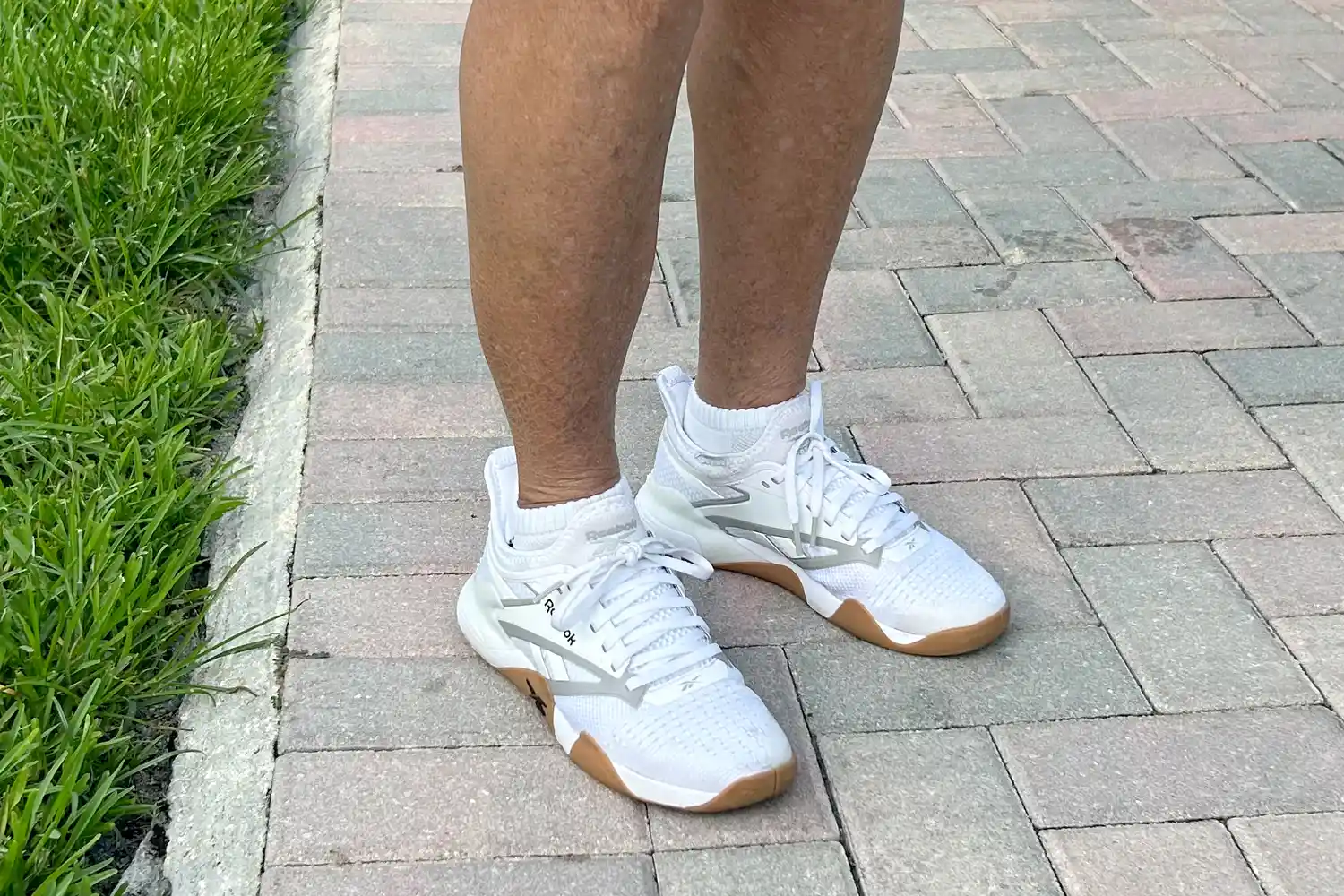 A front view of a person wearing the Reebok Women's Nano Court Shoes